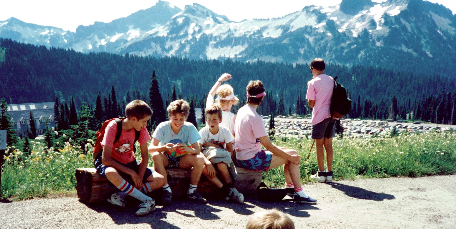 Family hiking in the mountains with friends.